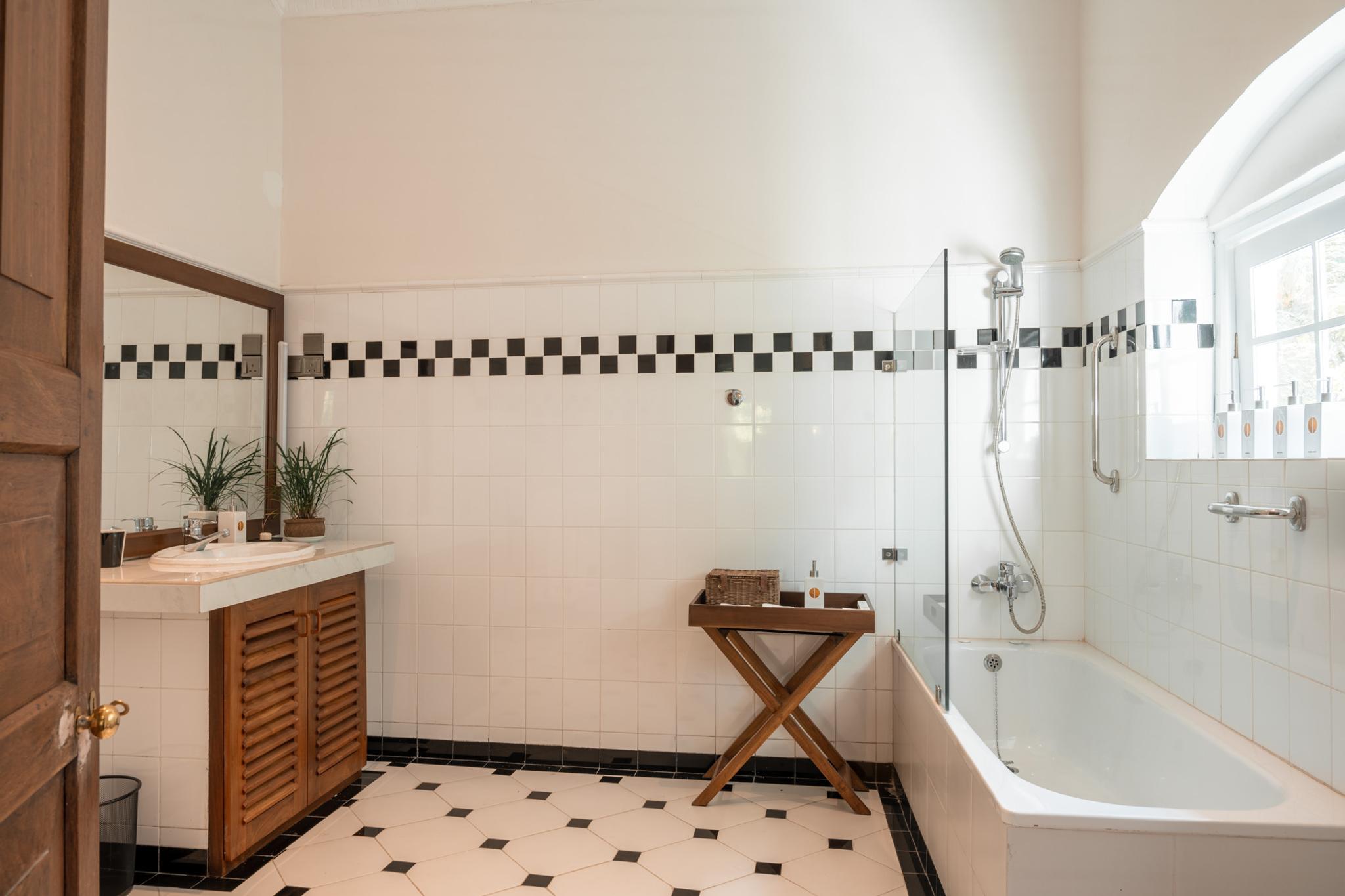 Elegant vanity sink and Shower amenities at Manor House Suites