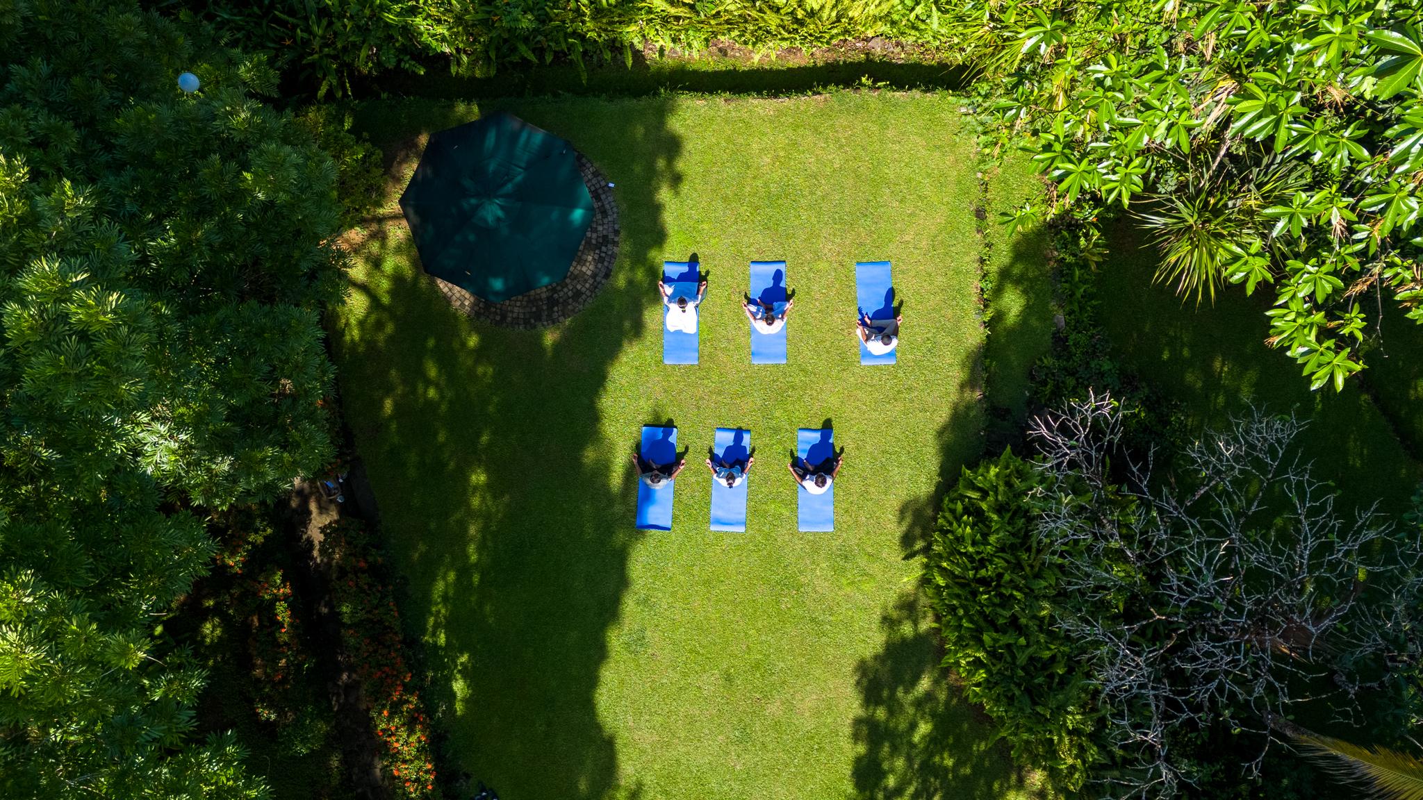 Aerial view of guests engaging in outdoor morning meditation